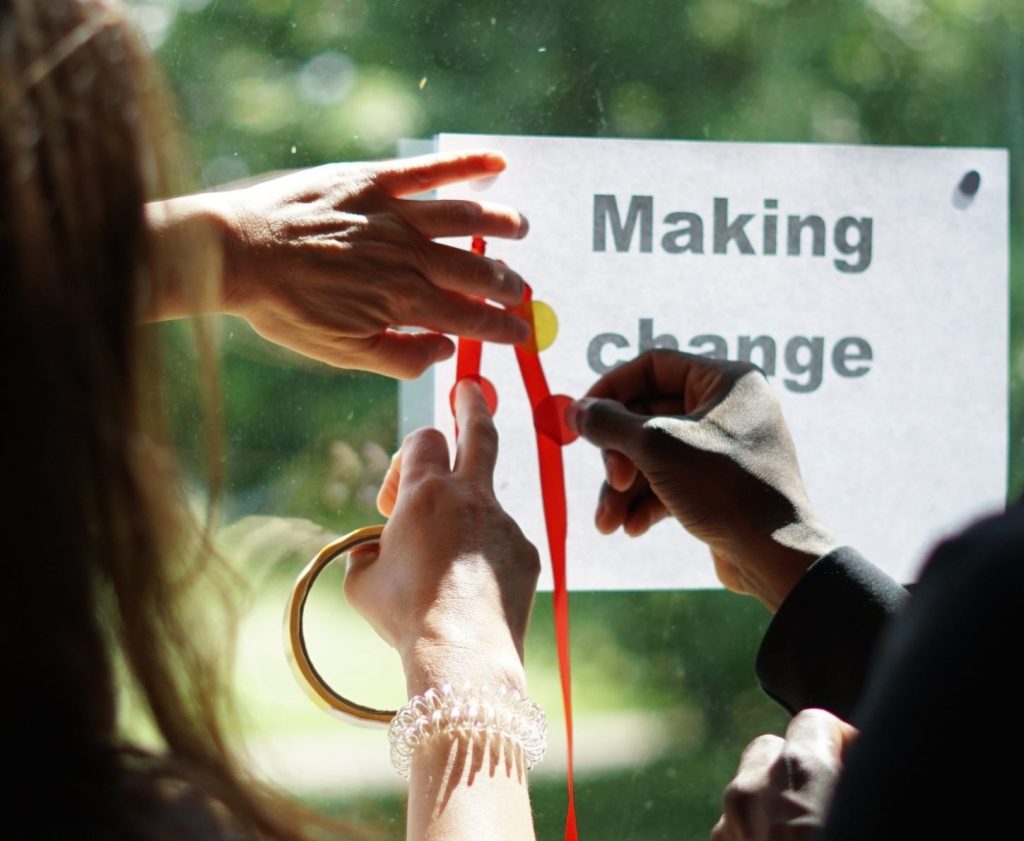 Hands writing making change